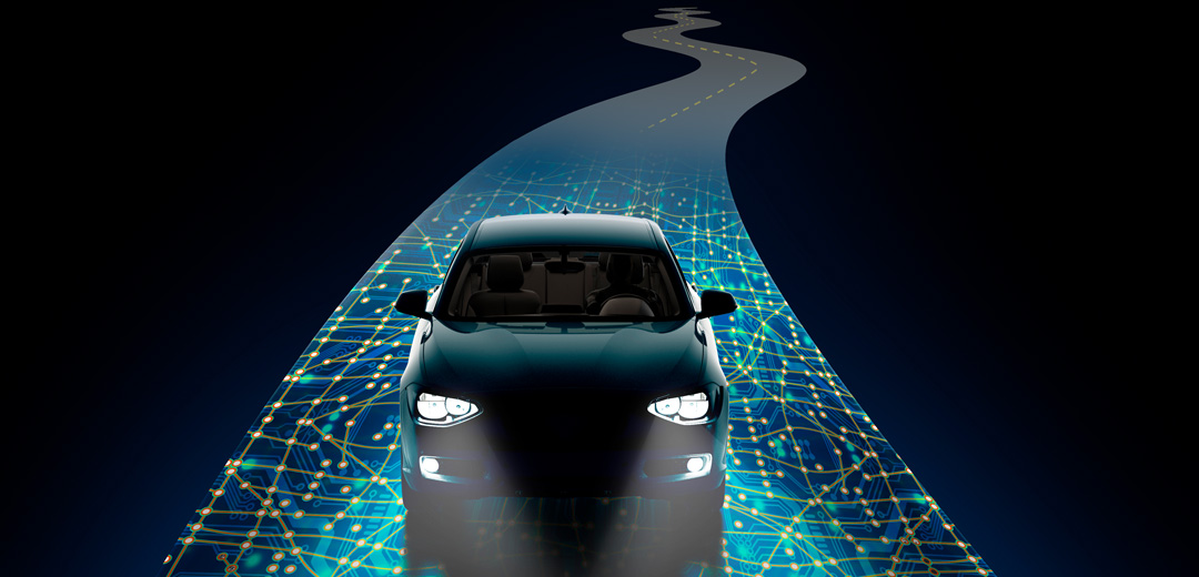 photo of a car with headlights shining driving down a road